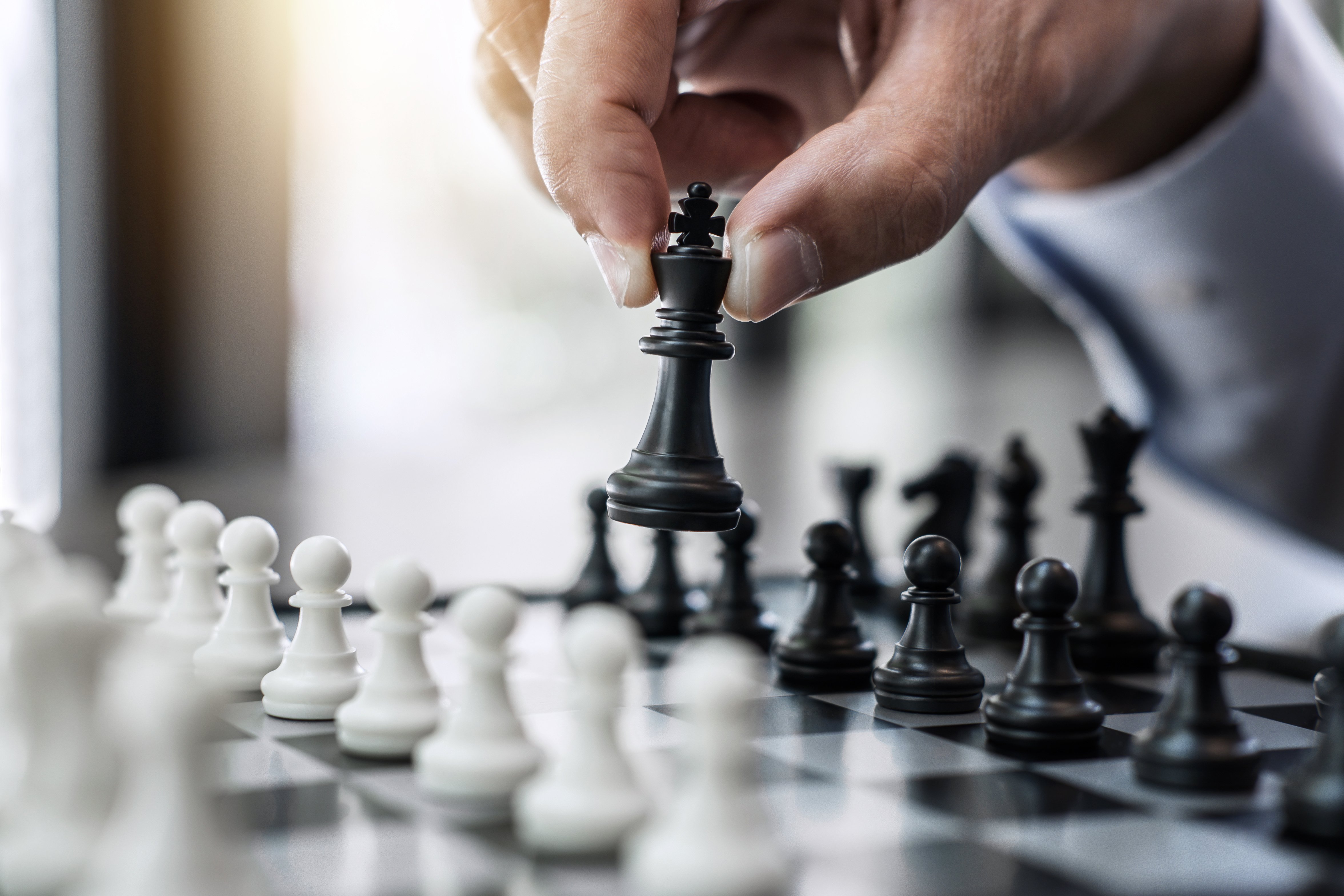 Businessman's Hand Playing Chess Game to Development Analysis